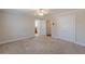 A simple bedroom with carpet, two doors, overhead light, and neutral paint at 1303 Hill Se St, Atlanta, GA 30315
