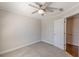 A neutral carpeted bedroom features a ceiling fan and two doors at 1303 Hill Se St, Atlanta, GA 30315