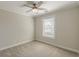 A well-lit bedroom featuring a ceiling fan and neutral carpeting at 1303 Hill Se St, Atlanta, GA 30315