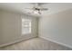 A carpeted room features a large window and a ceiling fan at 1303 Hill Se St, Atlanta, GA 30315