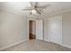 A simple bedroom features wall-to-wall carpeting, neutral paint and a ceiling fan at 1303 Hill Se St, Atlanta, GA 30315