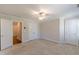 A carpeted bedroom features two doors, a ceiling fan, and neutral decor at 1303 Hill Se St, Atlanta, GA 30315