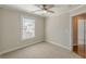 A well-lit bedroom featuring a ceiling fan and neutral carpeting at 1303 Hill Se St, Atlanta, GA 30315