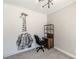 A bedroom featuring unique giraffe wall art, complemented by a dark bookshelf and an office chair at 1303 Hill Se St, Atlanta, GA 30315
