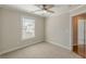 Neutral bedroom featuring plush carpeting, a window, and a ceiling fan at 1303 Hill Se St, Atlanta, GA 30315