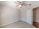 A gray carpeted bedroom displays a ceiling fan, white trim, and door entrances to other rooms at 1303 Hill Se St, Atlanta, GA 30315