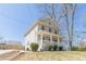 Side view of a charming two-story home featuring a welcoming front porch, manicured lawn and an inviting exterior at 1303 Hill Se St, Atlanta, GA 30315