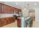 A kitchen with dark wood cabinets, stainless steel appliances, granite countertops, and an island with bar seating at 1303 Hill Se St, Atlanta, GA 30315