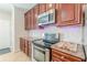 Kitchen features stainless steel oven and dark wood cabinets at 1303 Hill Se St, Atlanta, GA 30315