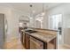 Kitchen showcasing a granite countertop island, stainless steel appliances, and archways at 1303 Hill Se St, Atlanta, GA 30315