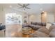 Open concept living space with hardwood floors, coffered ceilings, and gray sectional at 1303 Hill Se St, Atlanta, GA 30315