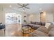 Living room features hardwood floors, gray sectional sofa, arched entryway, and decorative wall art at 1303 Hill Se St, Atlanta, GA 30315