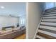 A living room featuring hardwood floors, a large sofa, and stairs leading to the upper level at 1303 Hill Se St, Atlanta, GA 30315