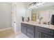 Bright bathroom featuring a vanity with double sinks and a large mirror above it at 1525 Camden Cove Dr, Cumming, GA 30040