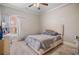 Neutral bedroom with a window and neutral colored decor with a bed and bedside table at 1525 Camden Cove Dr, Cumming, GA 30040