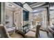 Stunning dining room with a modern chandelier, glass table and plenty of natural light at 1525 Camden Cove Dr, Cumming, GA 30040