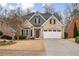 Charming brick two-story home with a well-manicured front yard and a two car garage at 1525 Camden Cove Dr, Cumming, GA 30040