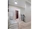 Second floor hallway featuring neutral walls, carpet and decorative railing with open doorway to closet space at 1525 Camden Cove Dr, Cumming, GA 30040