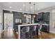 Modern kitchen with dark cabinets, a white countertop island, and stainless steel appliances at 1525 Camden Cove Dr, Cumming, GA 30040