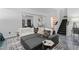 Open concept basement living room with gray floors, large gray couch, stairs and access to bathroom at 1525 Camden Cove Dr, Cumming, GA 30040