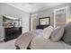 Spacious main bedroom featuring a TV, dresser, and windows for ample natural light at 1525 Camden Cove Dr, Cumming, GA 30040