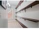 Walk-in closet with wooden shelves attached to the wall, providing ample storage space at 1525 Camden Cove Dr, Cumming, GA 30040