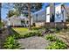 Spacious backyard area with gravel, grass, landscaping and a wooden privacy fence at 32 Howell Se St, Atlanta, GA 30312