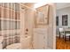 Cozy bathroom features tub/shower, light fixtures, sink, and tile flooring at 32 Howell Se St, Atlanta, GA 30312