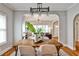 Inviting dining room with hardwood floors and contemporary light fixture opens to a cozy living space at 32 Howell Se St, Atlanta, GA 30312