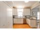 The kitchen features white cabinets, stainless appliances, and hardwood floors, creating a clean and modern look at 32 Howell Se St, Atlanta, GA 30312