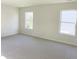 Bright and airy bedroom with two windows, neutral carpet, and ample space at 3925 Fairhaven Rd, Lithia Springs, GA 30122