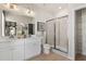 Bright and modern bathroom features double sinks, white cabinets, a glass shower, and ample storage at 525 Rubato Knl, Mcdonough, GA 30253