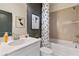 Modern bathroom features a sleek vanity, decorative art, and a shower-tub combination at 525 Rubato Knl, Mcdonough, GA 30253