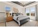 Bright bedroom with tray ceiling, recessed lights, modern chandelier, and large windows offering views at 525 Rubato Knl, Mcdonough, GA 30253