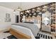 Stylized bedroom with modern lighting, vibrant wallpaper, and decor for luxurious and comfortable living at 525 Rubato Knl, Mcdonough, GA 30253