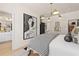 A luxury bedroom features a modern chandelier, bedside decor, and is connected to a spacious bathroom at 525 Rubato Knl, Mcdonough, GA 30253
