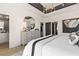 A luxury bedroom with tray ceiling, a modern chandelier, and stylish furniture; bathroom in view at 525 Rubato Knl, Mcdonough, GA 30253