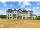 Rows of contemporary townhomes featuring a mix of siding and brick, complemented by young trees at 525 Rubato Knl, Mcdonough, GA 30253