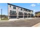 Stunning exterior of townhomes showcasing private balconies and attached two-car garages at 525 Rubato Knl, Mcdonough, GA 30253