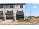 Beautiful townhome exterior featuring a private balcony, gray two-car garage, and a landscaped entrance at 525 Rubato Knl, Mcdonough, GA 30253