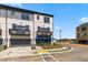 Stunning townhome exterior showcasing private balconies, attached two-car garage, and a beautifully landscaped entrance at 525 Rubato Knl, Mcdonough, GA 30253