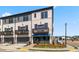 Stylish townhome exterior with gray two-car garages, private balconies, and manicured landscaping at 525 Rubato Knl, Mcdonough, GA 30253
