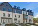 Striking townhome featuring classic architectural details and a professionally landscaped front yard at 525 Rubato Knl, Mcdonough, GA 30253