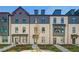 Charming townhome featuring classic architectural details and a professionally landscaped front yard at 525 Rubato Knl, Mcdonough, GA 30253