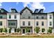 Charming multi-story townhome with a mix of brick and siding, showcasing a well-maintained front yard at 525 Rubato Knl, Mcdonough, GA 30253