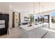 Open floor plan shows kitchen island with seating connecting to the dining area at 525 Rubato Knl, Mcdonough, GA 30253