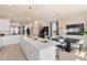 Modern open floor plan featuring a kitchen island with pendant lights and dining area with stylish furniture at 525 Rubato Knl, Mcdonough, GA 30253