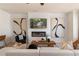 This is a cozy living room featuring a sleek fireplace, TV, comfortable couch, and stylish decor at 525 Rubato Knl, Mcdonough, GA 30253