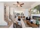 This stylish living room features a modern fireplace, a large flatscreen, and a view into the kitchen at 525 Rubato Knl, Mcdonough, GA 30253