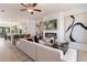 Open-concept living room with modern fireplace, TV, and view into the kitchen at 525 Rubato Knl, Mcdonough, GA 30253
